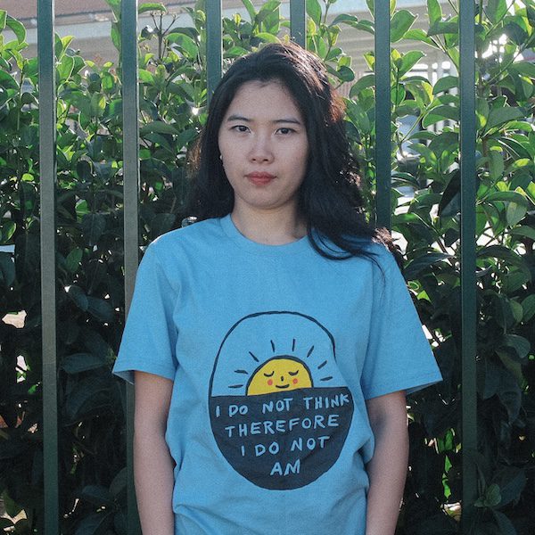 Person wearing a blue T-shirt with the script 'I do not think therefore I do not am' from the Lonely Kids Club